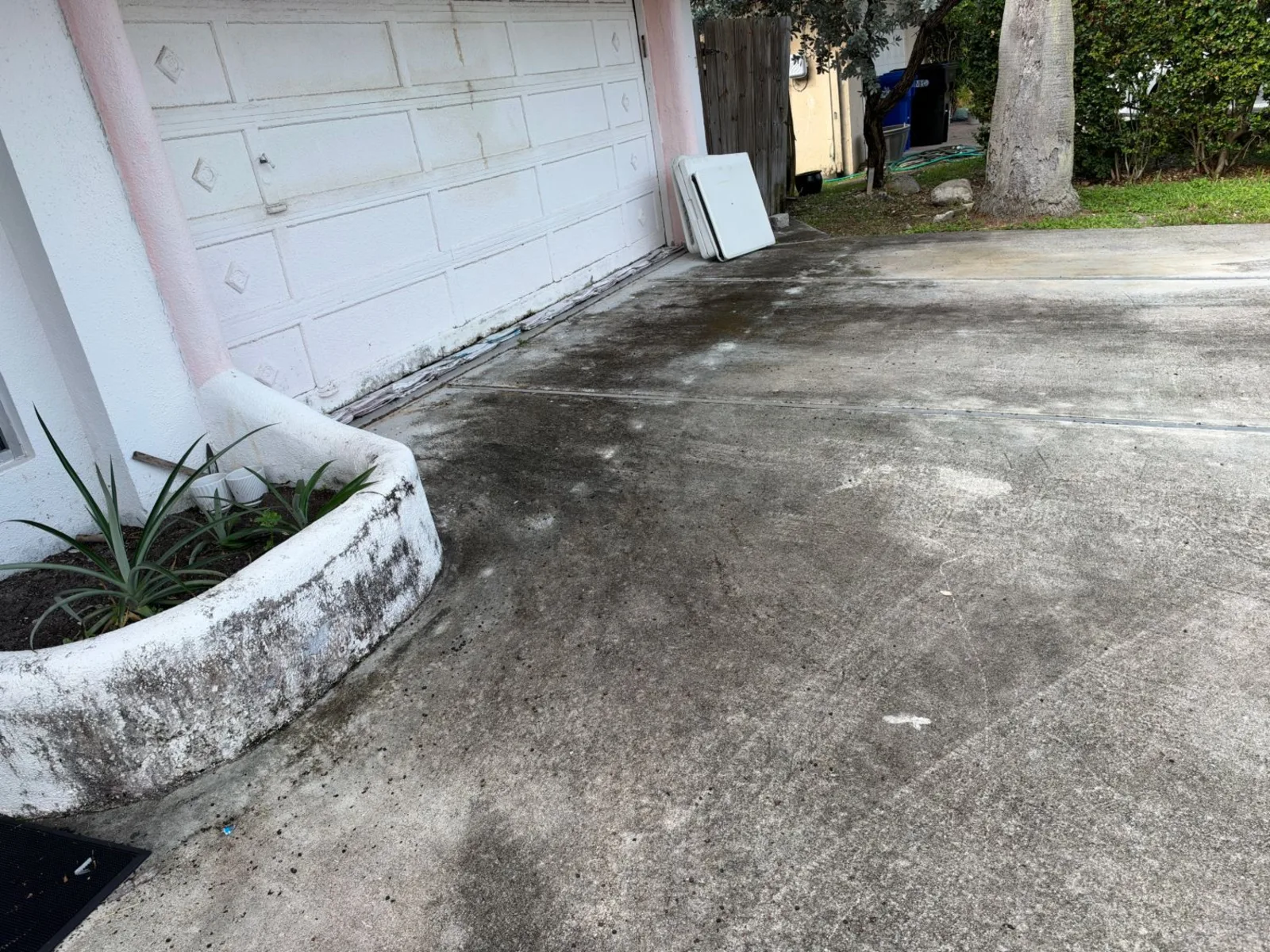 Before: driveway by the garage door