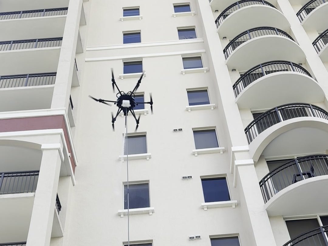 Drone cleaning a high-rise building facade